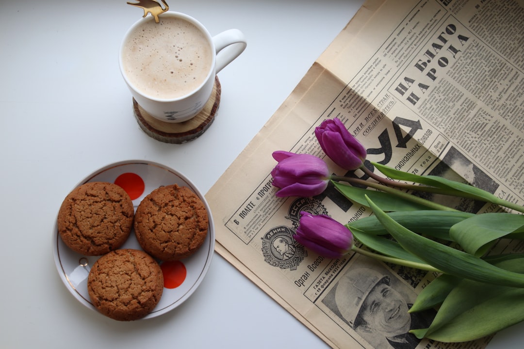 white-ceramic-mug-with-coffee-beside-purple-flower-1-tzyz5oa-q